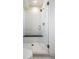 Beautiful bathroom features a frameless glass-enclosed shower, a seat, and white subway tile surround at 2012 W 46Th Ave, Denver, CO 80211