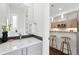 Stylish bathroom with modern fixtures, sleek vanity, and a view of the kitchen bar seating at 2830 W 32Nd Ave, Denver, CO 80211