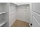 A walk-in closet featuring neutral carpeting, shelves, and a window for natural light at 2830 W 32Nd Ave, Denver, CO 80211