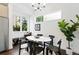 Bright dining area featuring modern lighting, and dark hardwood floors at 2830 W 32Nd Ave, Denver, CO 80211