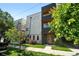 Modern multi-story townhome featuring light gray stucco, dark accents, landscaping, and a touch of greenery at 2830 W 32Nd Ave, Denver, CO 80211