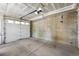 An empty two-car garage featuring a concrete floor and walls, with an overhead door and motor in place at 2830 W 32Nd Ave, Denver, CO 80211