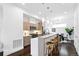 Modern kitchen featuring stainless steel appliances, light wood cabinetry, and a stylish breakfast bar with seating at 2830 W 32Nd Ave, Denver, CO 80211