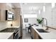 A contemporary kitchen featuring stainless steel appliances, light wood cabinetry, and an adjacent dining area at 2830 W 32Nd Ave, Denver, CO 80211