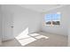 Sunlit bedroom boasts neutral carpet, a window with views, and a classic white door at 5625 W 141 Ln, Broomfield, CO 80020