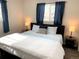 Bright bedroom featuring a comfortable bed with a large window and neutral decor at 2200 W Moffat Pl, Denver, CO 80221