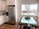 Bright dining area adjacent to kitchen with stainless steel refrigerator and neighborhood views at 2200 W Moffat Pl, Denver, CO 80221