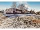 Charming home with brick accents, snow covered yard, and inviting front entrance at 2200 W Moffat Pl, Denver, CO 80221