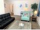 A modern living room with bright artwork, comfortable furniture and a cozy accent chair at 2200 W Moffat Pl, Denver, CO 80221