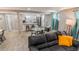 Comfortable living room with an open layout, flowing into a sleek kitchen and dining space at 2200 W Moffat Pl, Denver, CO 80221