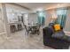 Inviting living room with an open floor plan, seamlessly connecting to a modern kitchen and dining area at 2200 W Moffat Pl, Denver, CO 80221
