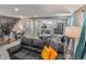 Well-lit living room featuring an open design with an adjacent kitchen, dining area, and workspace at 2200 W Moffat Pl, Denver, CO 80221