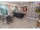 Finished basement boasts a dining area, lounge seating and a decorative accent wall at 2200 W Moffat Pl, Denver, CO 80221