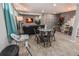 Basement living area features a dining area, lounge seating and a decorative accent wall at 2200 W Moffat Pl, Denver, CO 80221