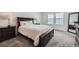 Comfortable bedroom with large bed, dark wood furniture and a bright, airy feel at 17402 W 93Rd Pl, Arvada, CO 80007