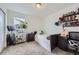 Bright, carpeted bedroom with organized bookshelf and desk next to a cozy sleeping area at 17402 W 93Rd Pl, Arvada, CO 80007