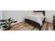 Cozy bedroom with hardwood floors, plush bedding, and a decorative potted plant at 17402 W 93Rd Pl, Arvada, CO 80007