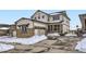 Charming two-story home with a two-car garage, stone accents, and a well-maintained driveway at 17402 W 93Rd Pl, Arvada, CO 80007