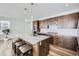 Contemporary kitchen featuring a center island with bar stools, stainless steel appliances, and modern lighting at 17402 W 93Rd Pl, Arvada, CO 80007