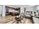 Open concept living room flowing into the kitchen, featuring stylish furniture and hardwood floors at 17402 W 93Rd Pl, Arvada, CO 80007