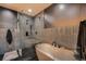 Contemporary bathroom showcasing a freestanding tub and glass-enclosed shower with black hexagon tiles at 1401 Delgany St # 409, Denver, CO 80202