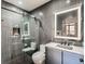 Modern bathroom featuring an enclosed glass shower, updated sink and dark, textured walls at 1401 Delgany St # 409, Denver, CO 80202