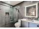 Modern bathroom with glass-enclosed shower, sleek toilet, and illuminated mirror above a stylish vanity at 1401 Delgany St # 409, Denver, CO 80202