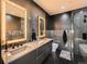 Modern bathroom featuring dual sinks, unique black and gray tile, and a glass shower at 1401 Delgany St # 409, Denver, CO 80202