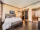 Bedroom with wood trim, accent wall, and barn door access to the modern bathroom at 1401 Delgany St # 409, Denver, CO 80202