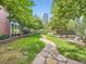 Stone pathway through the green lawn common area, surrounded by trees at 1401 Delgany St # 409, Denver, CO 80202