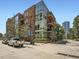 Brick building exterior view with glass windows, balconies, and a glimpse of the cityscape at 1401 Delgany St # 409, Denver, CO 80202