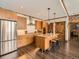 Well-equipped kitchen featuring a central island, stainless steel appliances, and stylish hardwood floors at 1401 Delgany St # 409, Denver, CO 80202