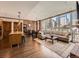 Open-concept living room featuring hardwood floors, exposed brick wall, and large windows with city views at 1401 Delgany St # 409, Denver, CO 80202