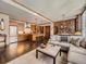 Open-concept living room showcasing a spacious kitchen, exposed brick, and comfortable living area at 1401 Delgany St # 409, Denver, CO 80202