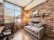 Cozy office space with exposed brick wall, comfortable seating, and urban view at 1401 Delgany St # 409, Denver, CO 80202