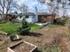 A spacious backyard with a garden area and a small tree near the house at 12116 W Texas Dr, Lakewood, CO 80228