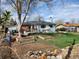 Large backyard featuring grass, garden boxes, a deck and a shed at 12116 W Texas Dr, Lakewood, CO 80228