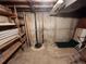 Basement with sump pump and wooden shelves at 12116 W Texas Dr, Lakewood, CO 80228