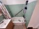 View of a bathroom featuring a bathtub with shower, tiled walls, and a sink at 12116 W Texas Dr, Lakewood, CO 80228