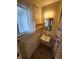 A small bathroom with a sink, mirror, and window, showing a shower curtain at 12116 W Texas Dr, Lakewood, CO 80228