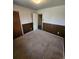 A bedroom featuring wood paneling and access to other rooms in the house at 12116 W Texas Dr, Lakewood, CO 80228