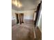 A bedroom featuring wood paneling, a window, and access to another room with closet at 12116 W Texas Dr, Lakewood, CO 80228