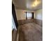 A bedroom featuring wood paneling, a window with curtains, and baseboard heating at 12116 W Texas Dr, Lakewood, CO 80228