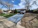 A well-maintained brick house with a driveway and landscaped yard at 12116 W Texas Dr, Lakewood, CO 80228