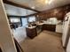 Efficient kitchen featuring traditional cabinets, a central island, and seamless access to the dining area at 12116 W Texas Dr, Lakewood, CO 80228
