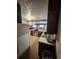 A kitchen with stainless steel appliances and a light colored floor and access to living spaces at 12116 W Texas Dr, Lakewood, CO 80228