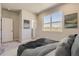 Calm bedroom featuring a soft carpet, neutral walls, and a large sunny window at 6993 Ipswich Ct, Castle Pines, CO 80108