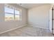 Neutral bedroom features a large window, plush carpet, and a closet door at 6993 Ipswich Ct, Castle Pines, CO 80108