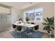 Cozy dining area with a modern table set and a large window offering neighborhood views at 6993 Ipswich Ct, Castle Pines, CO 80108