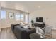 Modern living room with sleek furniture, neutral tones, and ample natural light at 6993 Ipswich Ct, Castle Pines, CO 80108